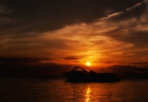 Boat sailing on the Caribbean Sea during a sunset HD