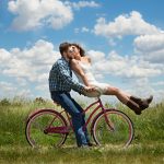 Loving Couple Riding On A Bike