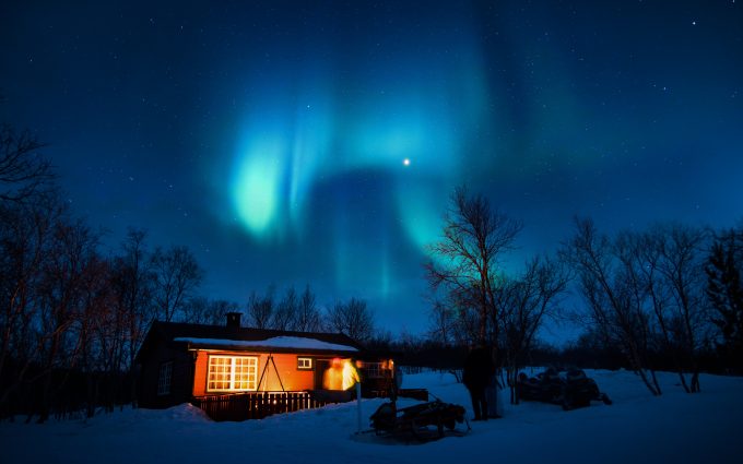 Aurora Borealis Over A Snowy House