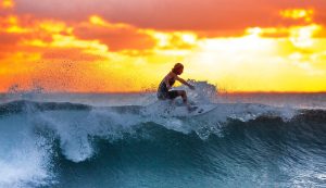 Man Surfing Waves at Sunset HD