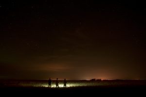 Three men watching stars at night 6K
