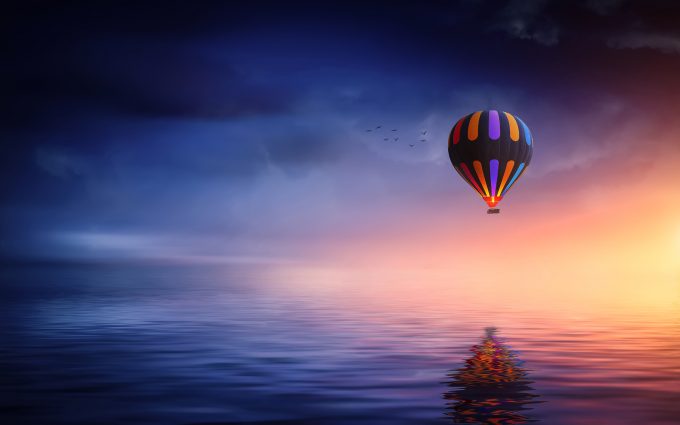 Hot Air Balloon Over The Ocean At Sunset