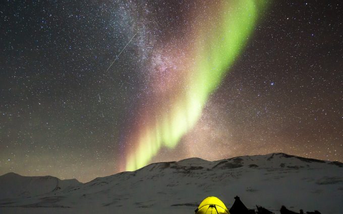 Aurora Borealis And Milky Way Above A Camp In The Snow