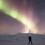 Man Looking At Aurora Borealis With A Starry Sky 5K